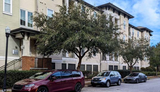 An elevated apartment building protects living areas from hurricane related storm surge, while allowing for parking under the living areas, as well as on-street parking.