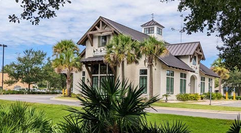 Pitched hurricane-resistant standing seam metal roof with a view tower add architectural interest to this bank building.
