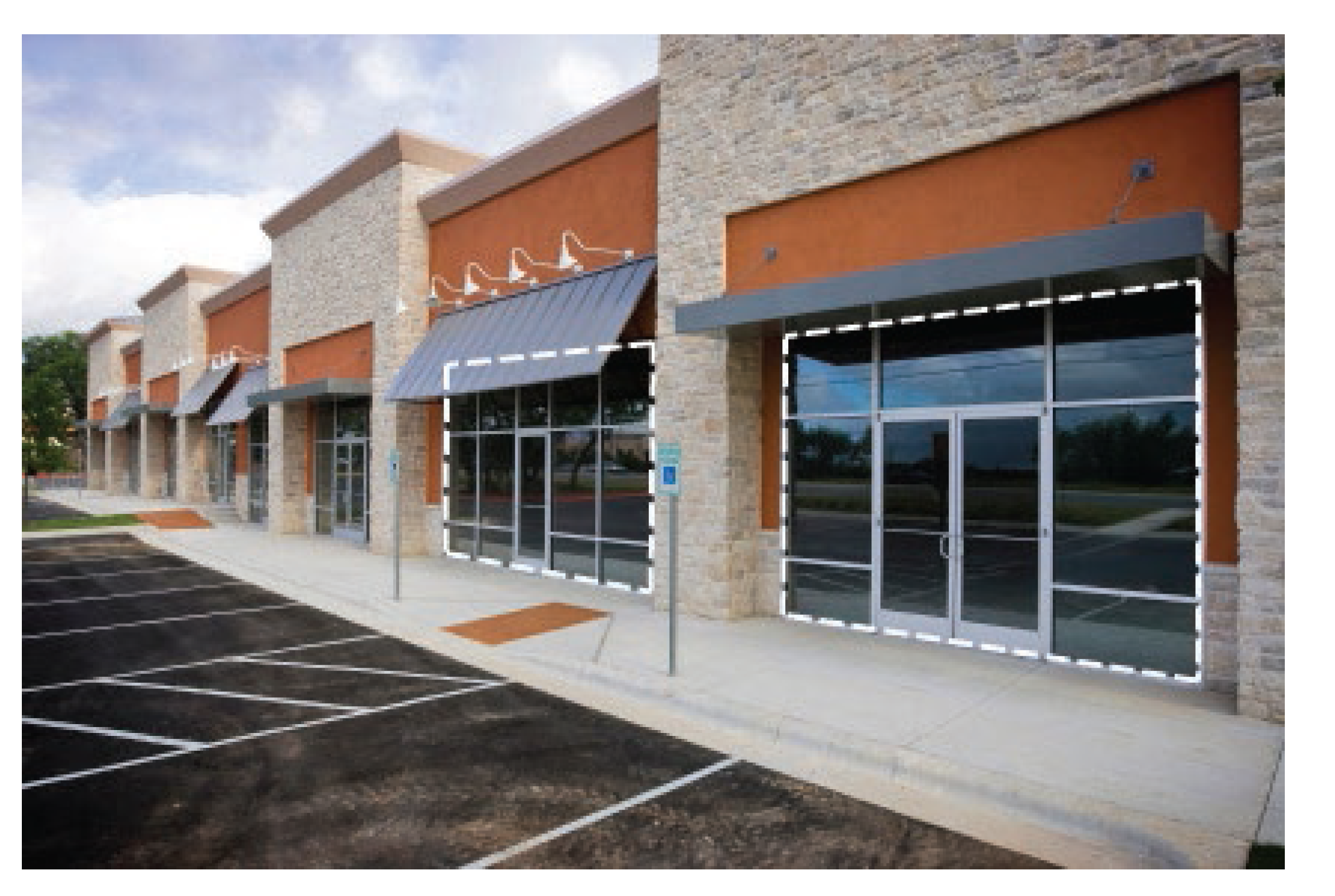 Figure 10-7 The window area is illustrated within the dashed line area for the two storefronts in the above image. The dashed lines highlight two separate window areas due to the separation by an architectural feature not related to the windows.