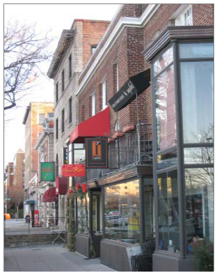 Small mixed-use buildings with individual Shopfronts.