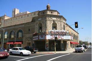 Retail uses along the ground floor of the Warnor's Theater conceal the large, windowless auditorium.
