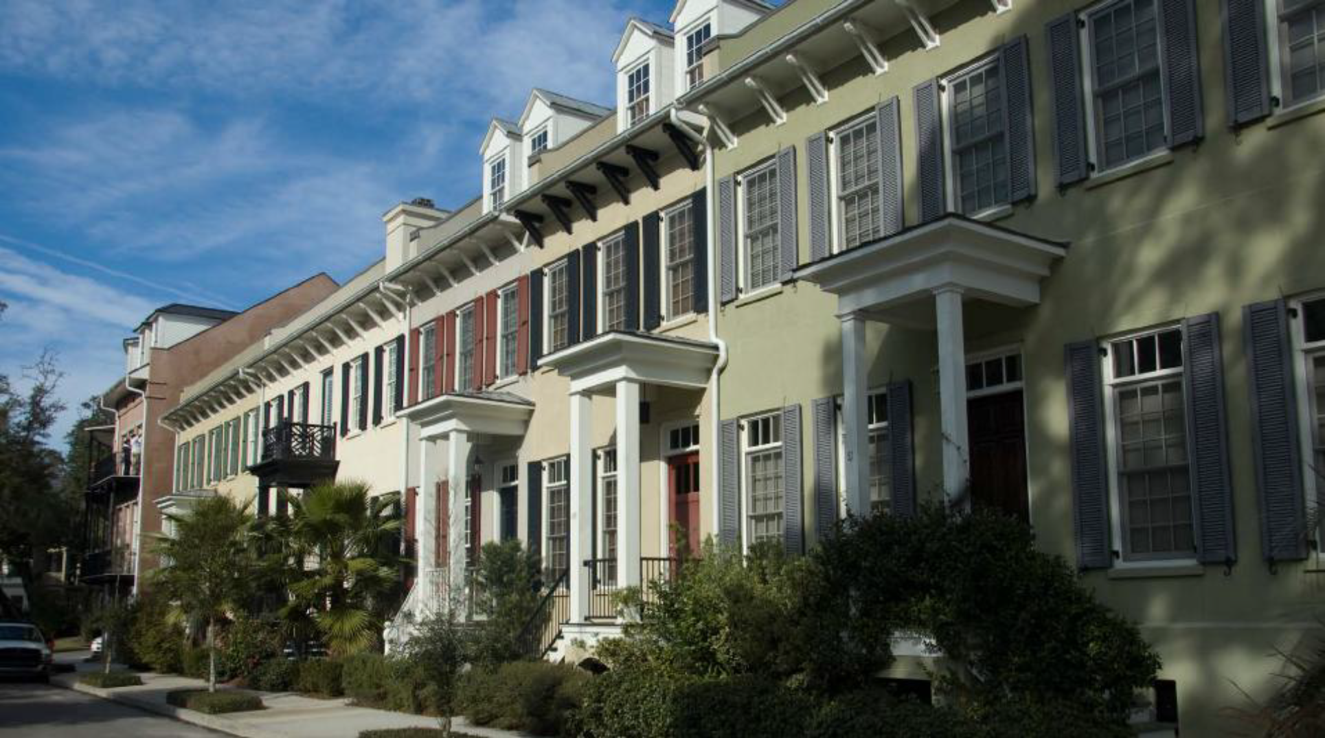 Individual stoops and dormers help to breakdown the overall massing of this row of townhouses
