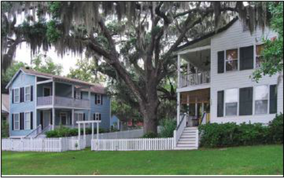 Two-story village house with a side yard porch