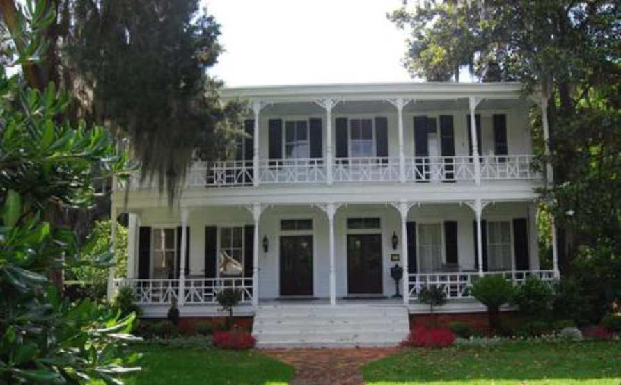 A side-by-side duplex with a balcony with a two-story porch