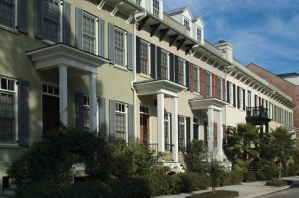 A series of stoops on townhouses with a minimum setback engage the street
