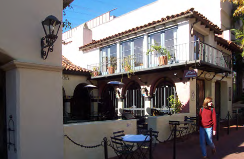 This commercial forecourt provides an outdoor dining area along a vibrant commercial street. The ROW is defined by a low wall as required by this Code.