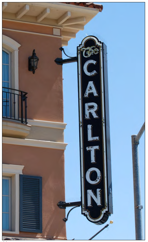 Marquee sign at corner terminating at eave.