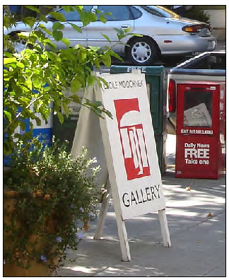Painted wood sidewalk sign.