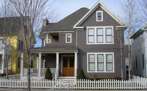 Two-story village house with an engaged porch.