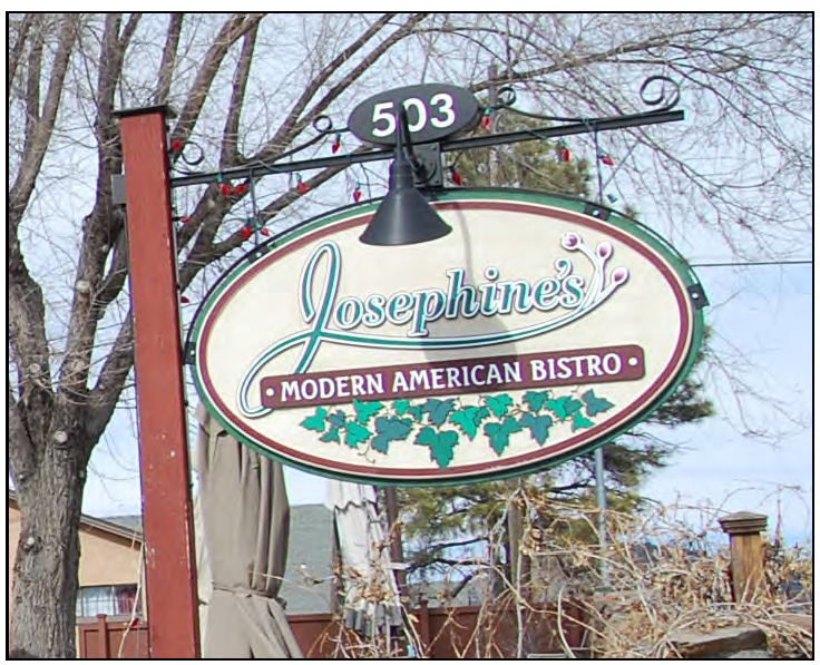 A simple yard sign advertising a small neighborhood cafe.