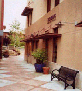 Textured paving, benches, and marquee display windows enhance this facade