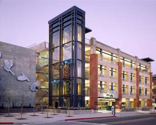 A tower element adds character to the parking structure similar to a commercial building.