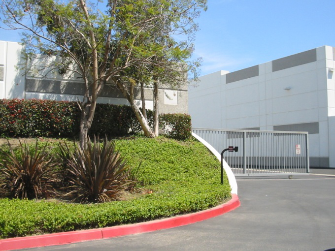 Berms, landscaping and an architecturally compatible wall provides adequate screening of service areas.