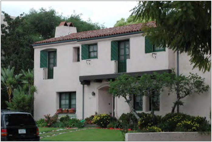 Example of a residential building that uses an overhanging room to break up its front façade.