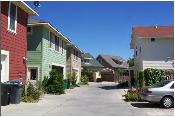 Example of a residential building that uses an overhanging room to break up its front façade.